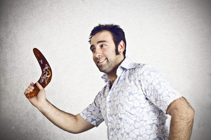 Man trowing a traditional boomerang